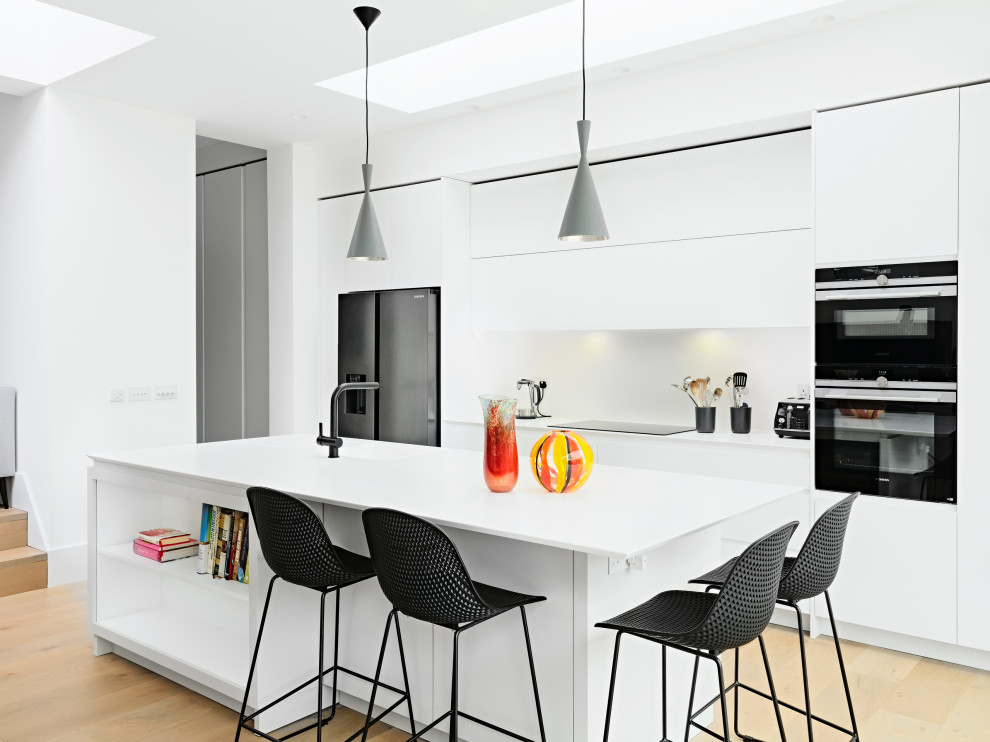 Источник вдохновения для домашнего уюта: прямая кухня среднего размера в современном стиле с обеденным столом, плоскими фасадами, белыми фасадами, островом и белой столешницей