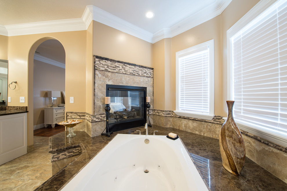 Photo of an expansive transitional master bathroom in Other with beige tile, porcelain tile, beige walls, porcelain floors, raised-panel cabinets, white cabinets, a drop-in tub, an open shower, an undermount sink, marble benchtops, beige floor and an open shower.