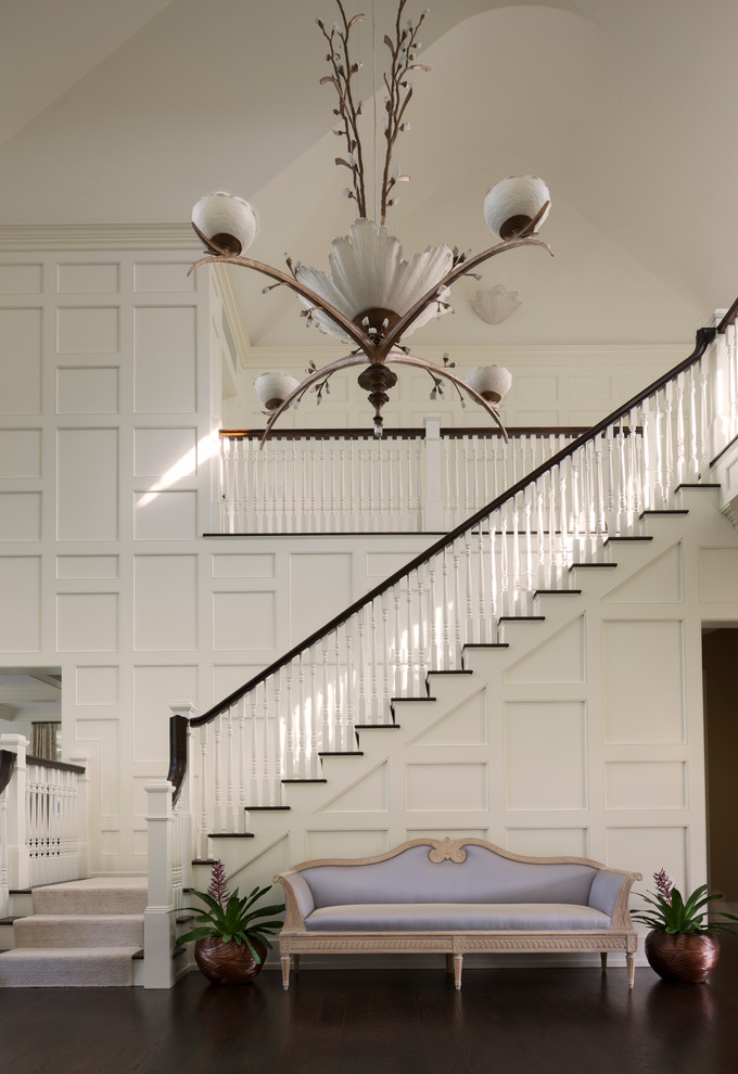 Foyer - huge transitional dark wood floor foyer idea in New York with white walls