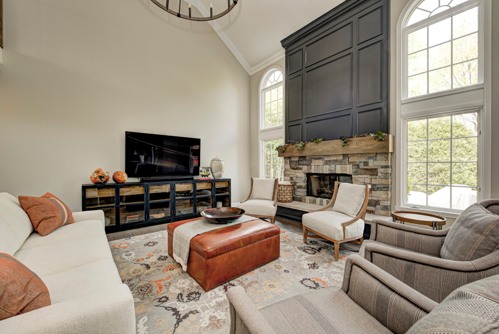 Photo of a mid-sized contemporary enclosed family room in Indianapolis with beige walls, dark hardwood floors, a standard fireplace, a stone fireplace surround and a wall-mounted tv.