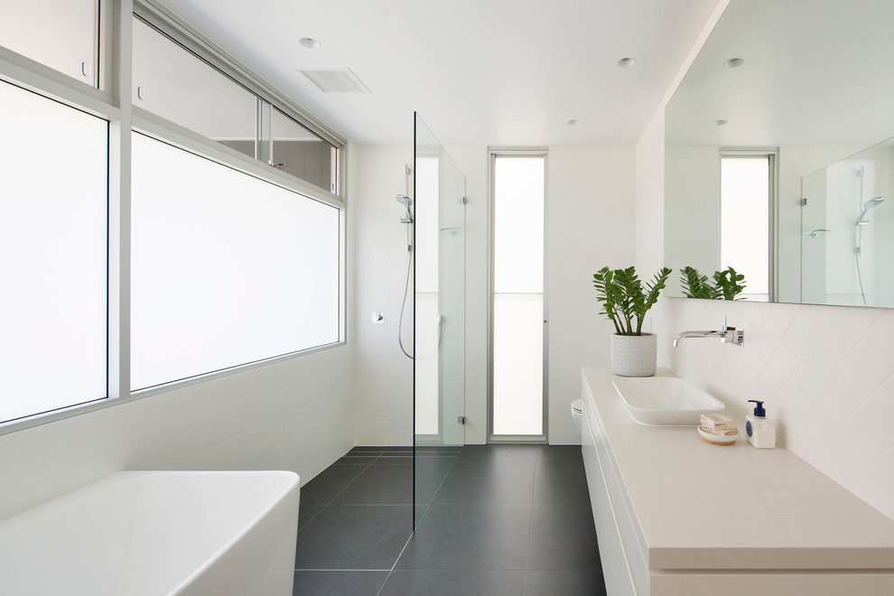 Photo of a large contemporary master bathroom in Sydney with a freestanding tub, an open shower, grey walls, ceramic floors, grey floor and an open shower.