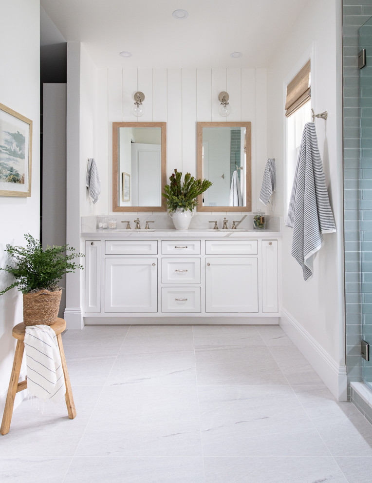 Design ideas for a beach style master bathroom in Orange County with shaker cabinets, white cabinets, an alcove shower, white walls, porcelain floors, an undermount sink, quartzite benchtops, white floor, a hinged shower door, white benchtops, a shower seat, a double vanity and a built-in vanity.