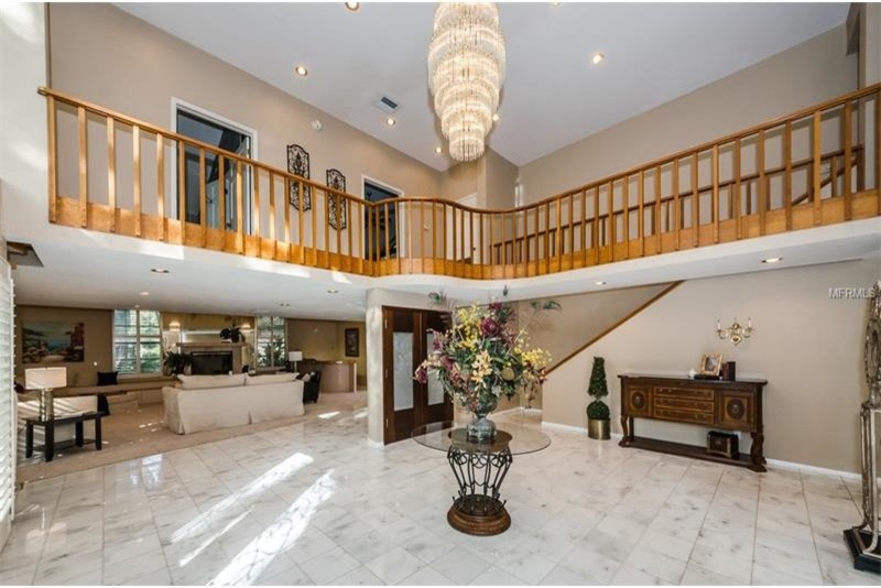 Large contemporary foyer in Tampa with beige walls and ceramic floors.