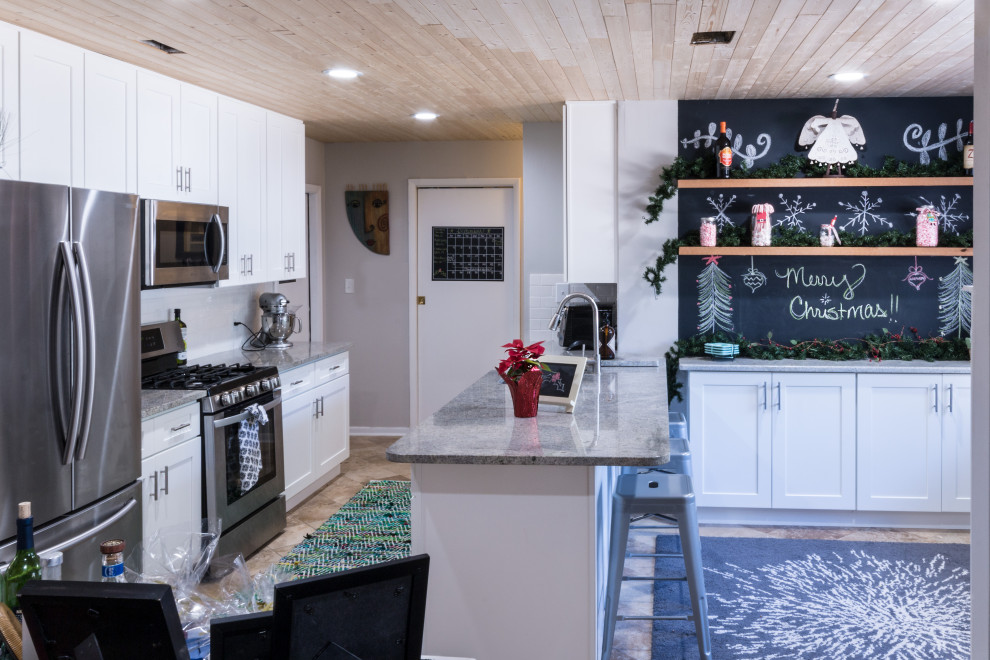 Inspiration for a small transitional cement tile floor and brown floor eat-in kitchen remodel with an undermount sink, shaker cabinets, white cabinets, granite countertops, white backsplash, cement tile backsplash, stainless steel appliances, a peninsula and white countertops