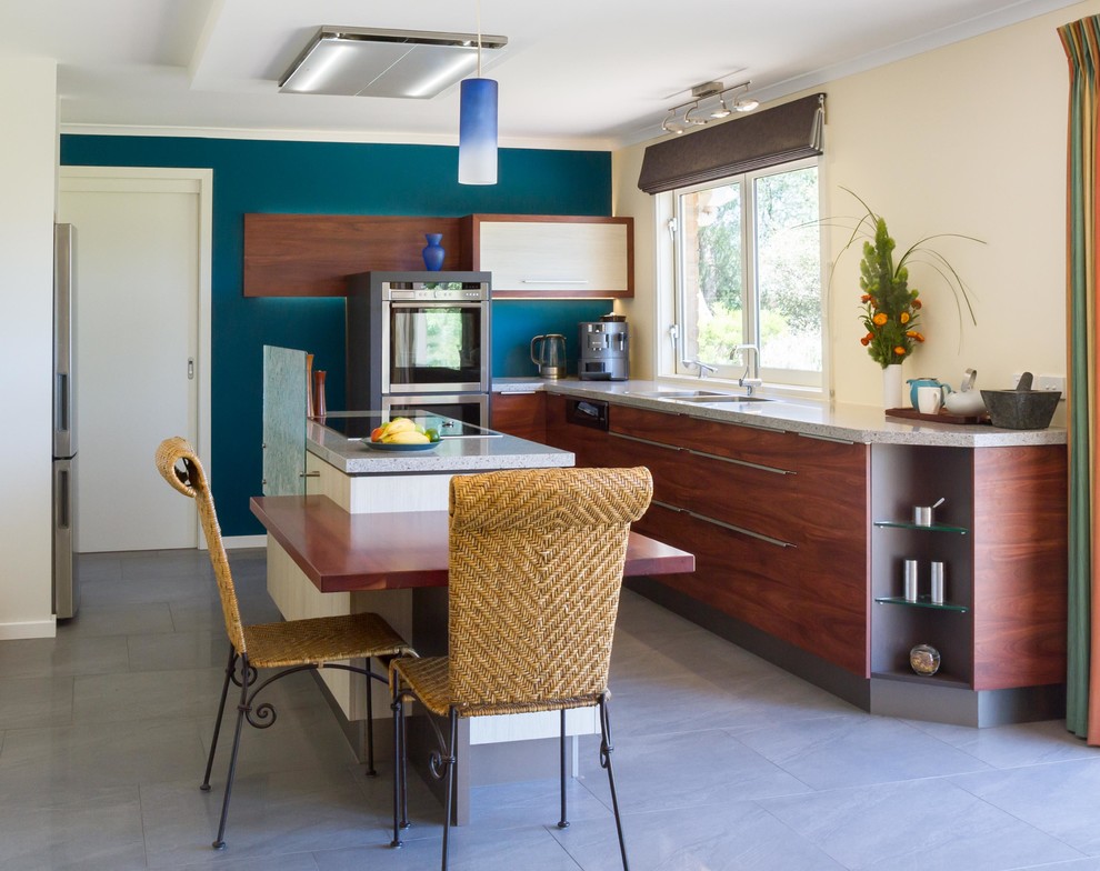 This is an example of a mid-sized contemporary l-shaped eat-in kitchen in Melbourne with flat-panel cabinets, medium wood cabinets, quartz benchtops and with island.