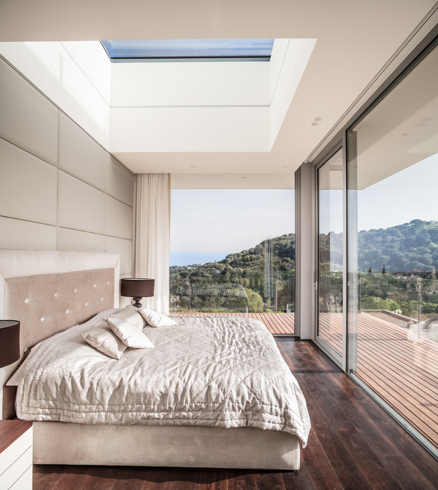 This is an example of a modern master bedroom in Other with dark hardwood floors, white walls and brown floor.