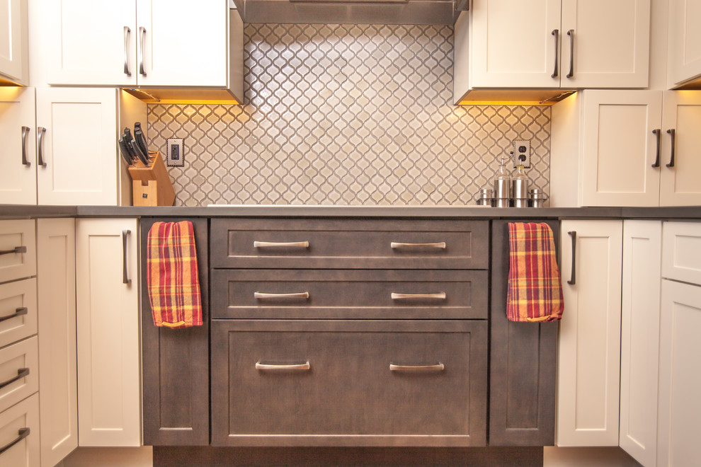 Inspiration for a mid-sized transitional u-shaped light wood floor eat-in kitchen remodel in Boise with a double-bowl sink, shaker cabinets, white cabinets, quartz countertops, white backsplash, ceramic backsplash, stainless steel appliances and an island