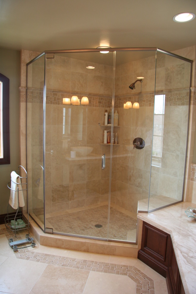 Mid-sized traditional master bathroom in Chicago with a vessel sink, dark wood cabinets, marble benchtops, a drop-in tub, a corner shower, a two-piece toilet, beige tile, stone tile, blue walls and marble floors.