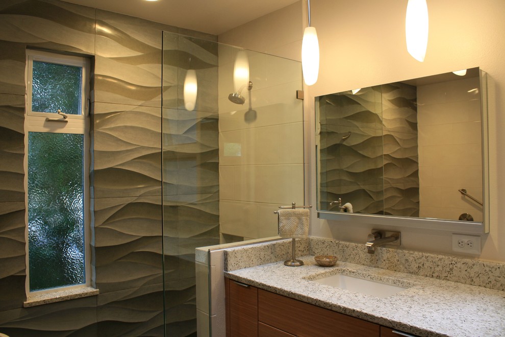 Inspiration for a large contemporary master bathroom in San Luis Obispo with flat-panel cabinets, medium wood cabinets, a drop-in tub, a curbless shower, gray tile, cement tile, white walls, pebble tile floors, an undermount sink, recycled glass benchtops, blue floor, an open shower and grey benchtops.