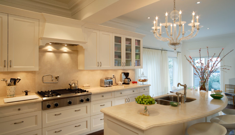 Enclosed kitchen - mid-sized transitional l-shaped medium tone wood floor enclosed kitchen idea in Toronto with a farmhouse sink, recessed-panel cabinets, white cabinets, quartz countertops, white backsplash, stainless steel appliances and an island