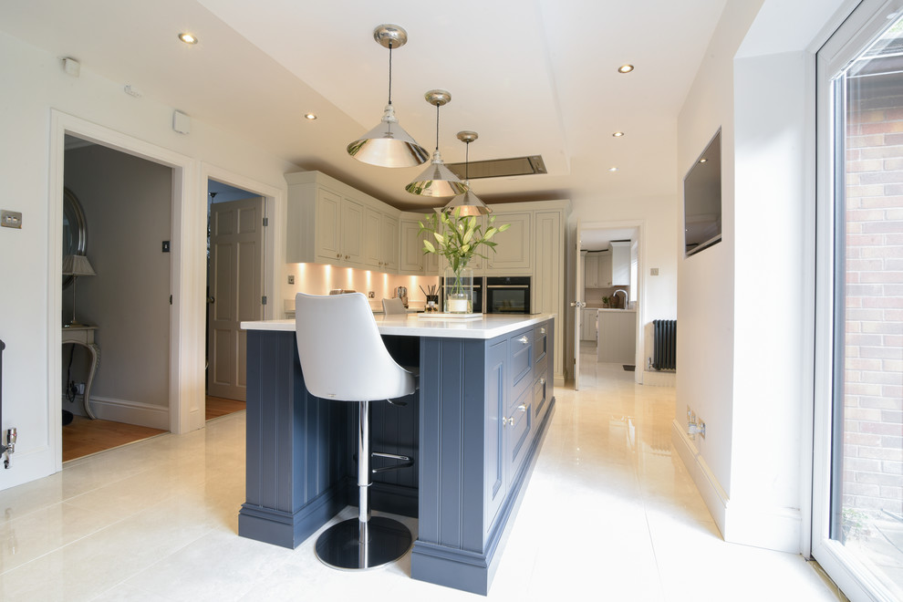 Design ideas for a large traditional u-shaped eat-in kitchen in Manchester with a drop-in sink, shaker cabinets, grey cabinets, granite benchtops, panelled appliances, porcelain floors, with island, white floor and white benchtop.