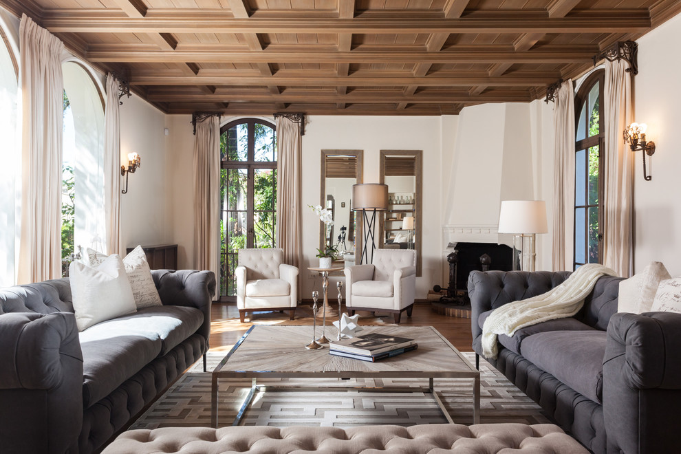 Example of a tuscan living room design in San Francisco with a corner fireplace