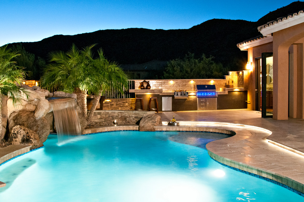 Inspiration for a transitional backyard stone and custom-shaped natural pool fountain remodel in Phoenix