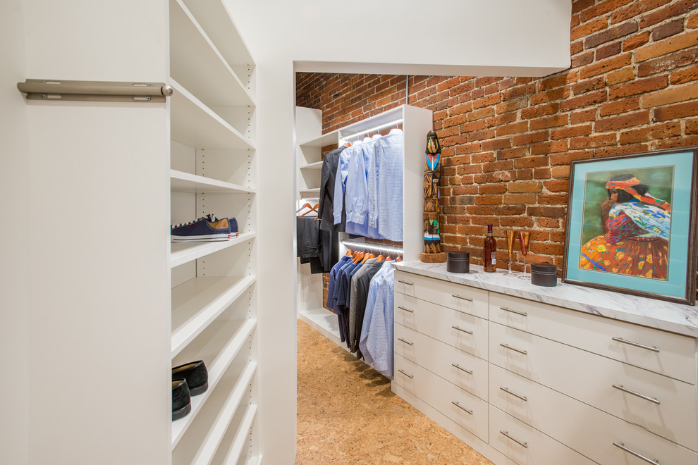 Inspiration for a mid-sized contemporary gender-neutral walk-in wardrobe in San Diego with flat-panel cabinets, white cabinets and cork floors.