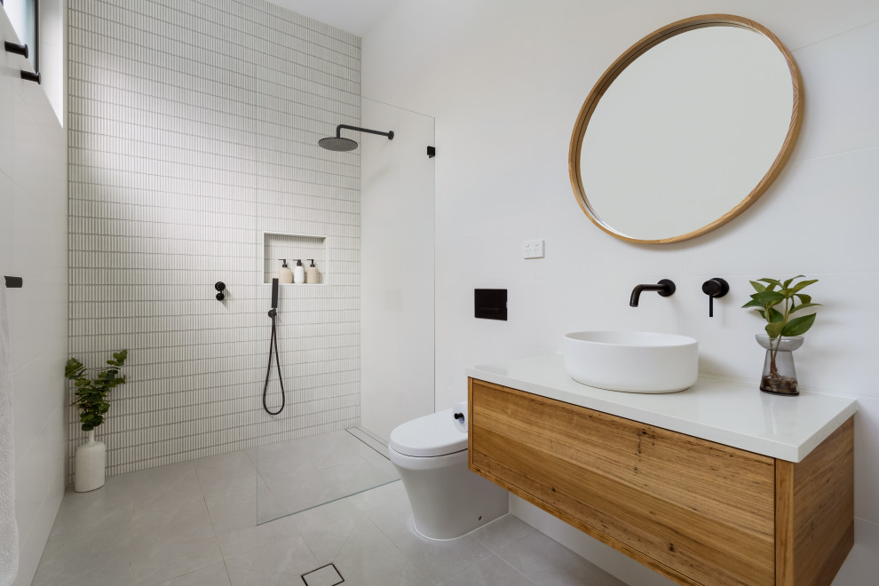 Bathroom - contemporary master white tile and porcelain tile gray floor and single-sink bathroom idea in Sydney with light wood cabinets, white walls, a vessel sink, quartz countertops, white countertops, a niche and a floating vanity