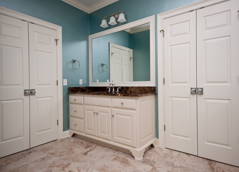 Mid-sized transitional master drop-in bathtub photo with blue walls and a hinged shower door