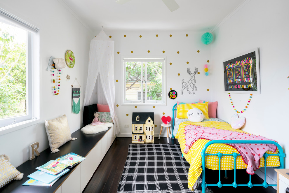 Photo of a transitional kids' bedroom for girls in Brisbane with white walls, dark hardwood floors and brown floor.