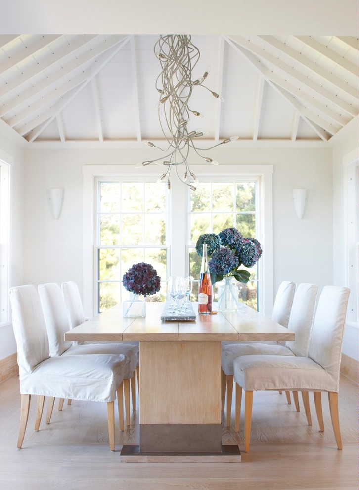 Photo of a transitional dining room in Boston with white walls and medium hardwood floors.