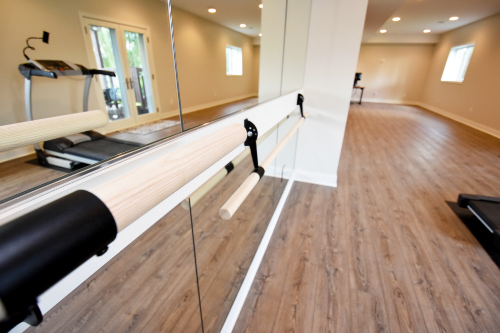 Photo of a large contemporary multipurpose gym in Minneapolis with beige walls, vinyl floors and brown floor.