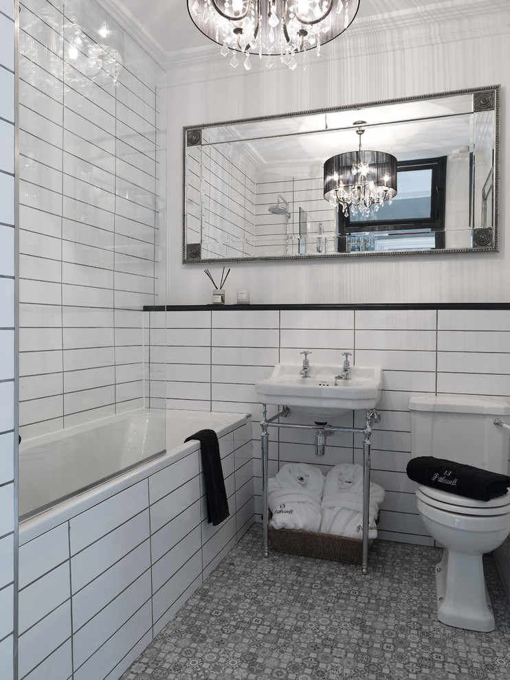 Inspiration for a mid-sized traditional bathroom in Other with a drop-in tub, white tile, white walls, a console sink and grey floor.