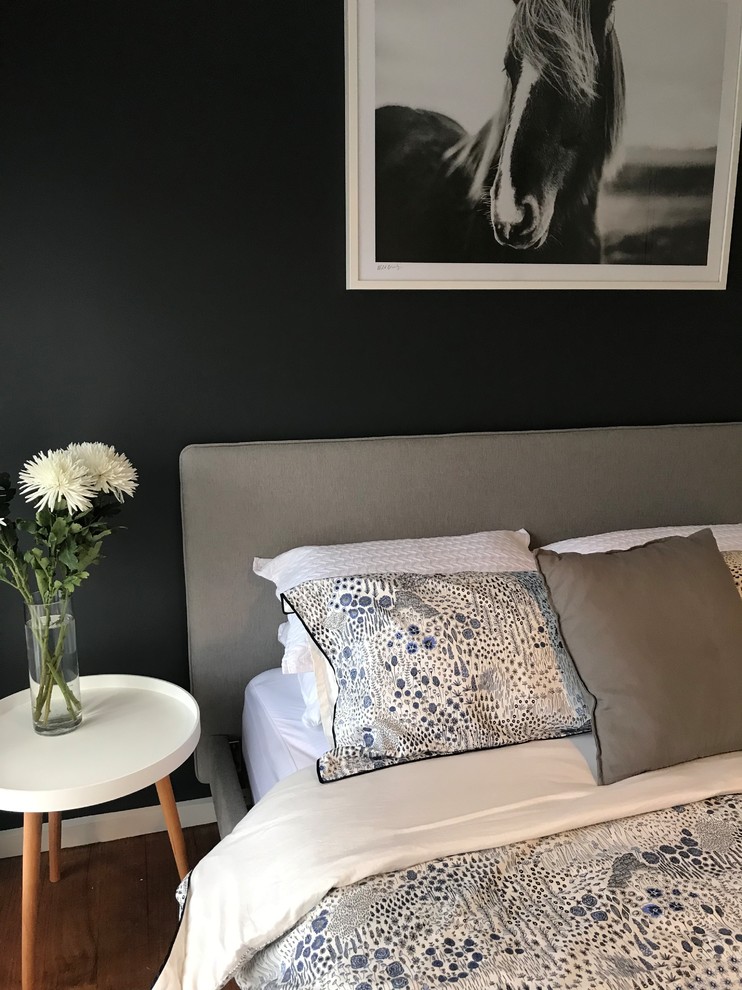 This is an example of an eclectic guest bedroom in Melbourne with grey walls and dark hardwood floors.