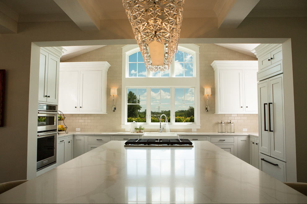 Mid-sized transitional u-shaped dark wood floor and brown floor open concept kitchen photo with a farmhouse sink, shaker cabinets, white cabinets, quartz countertops, beige backsplash, ceramic backsplash, paneled appliances and an island