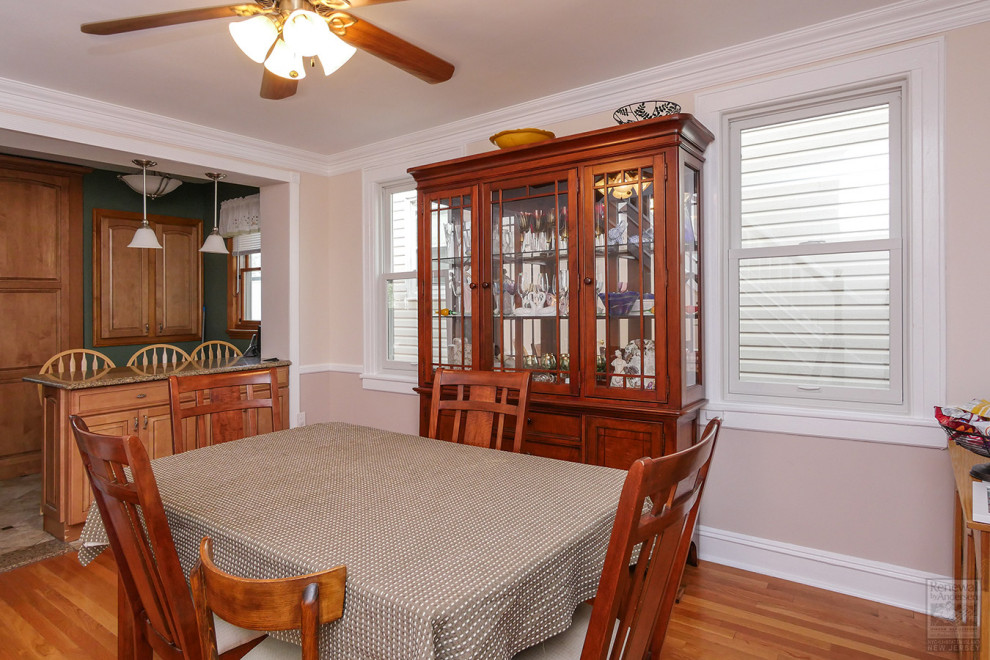 Mid-sized kitchen/dining combo in Newark with beige walls, medium hardwood floors, no fireplace and brown floor.