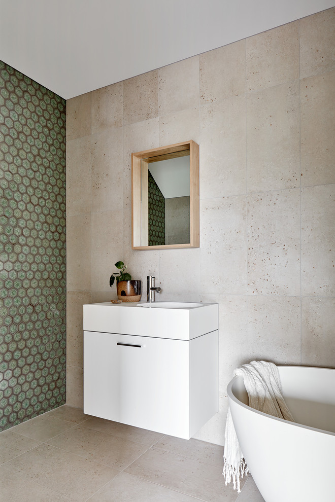 Photo of a small contemporary kids bathroom in Melbourne with furniture-like cabinets, white cabinets, a freestanding tub, an urinal, green tile, ceramic tile, grey walls, cement tiles, a wall-mount sink, solid surface benchtops, white benchtops, multi-coloured floor, an open shower, a niche, a single vanity, a floating vanity, an open shower and exposed beam.