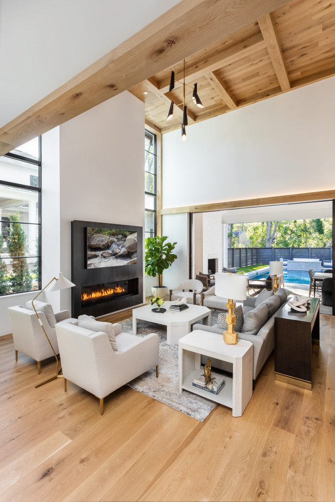 Large contemporary mezzanine living room in Other with white walls, light hardwood flooring, a ribbon fireplace, a wall mounted tv and a wood ceiling.