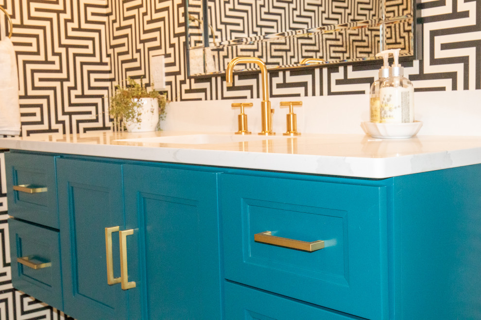 Inspiration for a mid-sized modern 3/4 bathroom in Grand Rapids with recessed-panel cabinets, turquoise cabinets, a one-piece toilet, white walls, concrete floors, an undermount sink, granite benchtops, grey floor, white benchtops, a single vanity, a floating vanity and wallpaper.