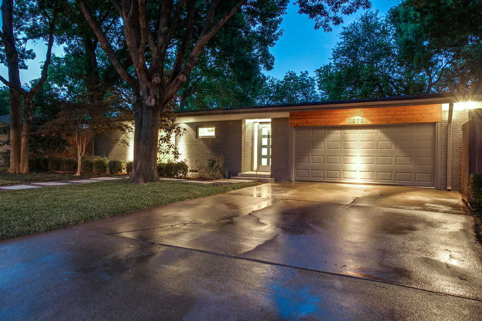 Design ideas for a mid-sized midcentury one-storey brick grey exterior in Dallas.