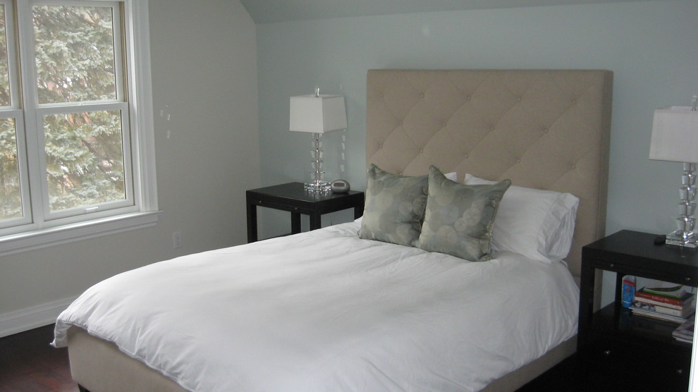 Mid-sized traditional master bedroom in Toronto with blue walls and dark hardwood floors.