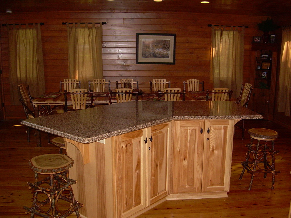 Mid-sized mountain style u-shaped medium tone wood floor and brown floor open concept kitchen photo with glass-front cabinets, light wood cabinets, granite countertops, brown backsplash, wood backsplash, stainless steel appliances and an island