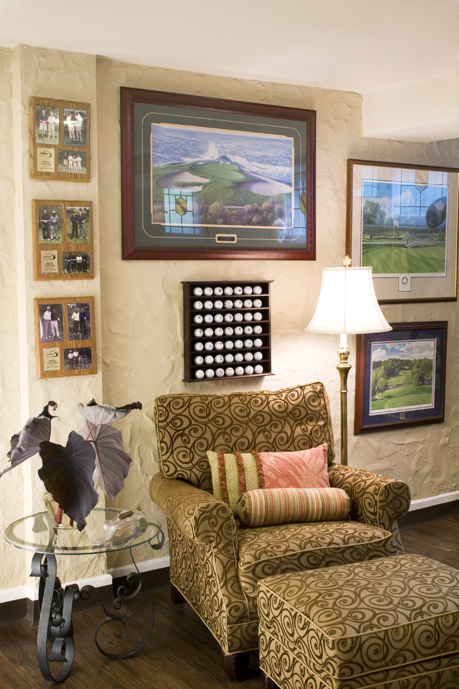 This is an example of a traditional family room in St Louis with beige walls, dark hardwood floors and no tv.