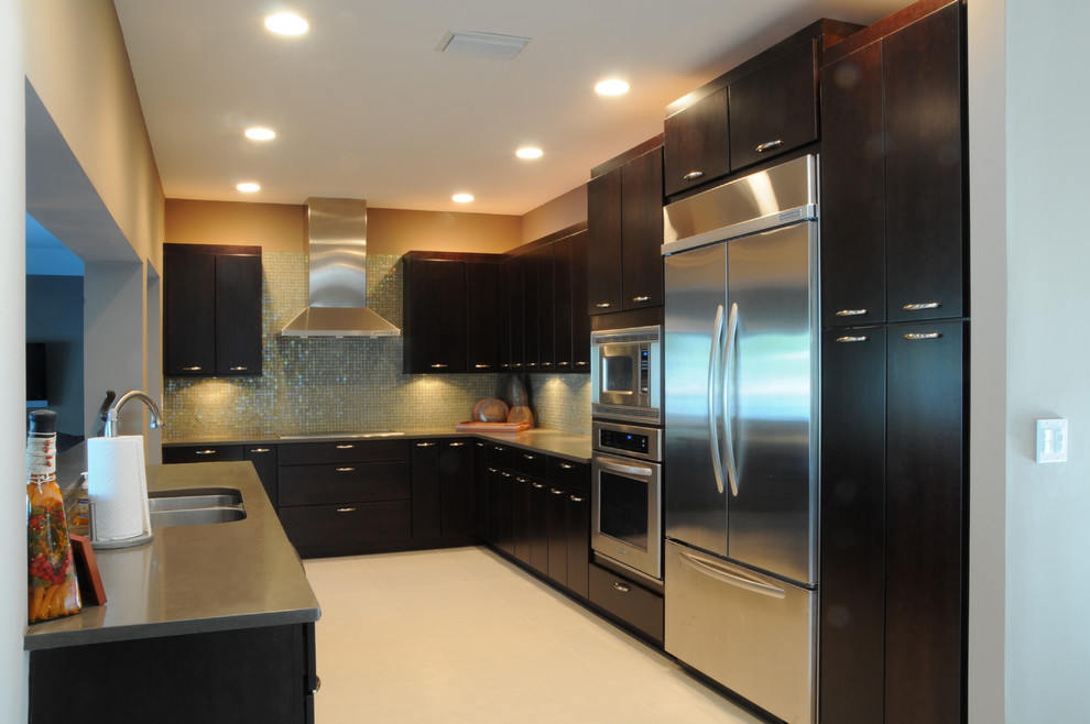 Large contemporary u-shaped eat-in kitchen in Tampa with an undermount sink, flat-panel cabinets, black cabinets, quartz benchtops, blue splashback, mosaic tile splashback, stainless steel appliances, porcelain floors, a peninsula, white floor and grey benchtop.