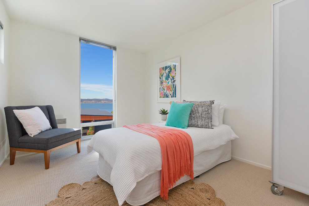 Small contemporary guest bedroom in Hobart with white walls, carpet and beige floor.