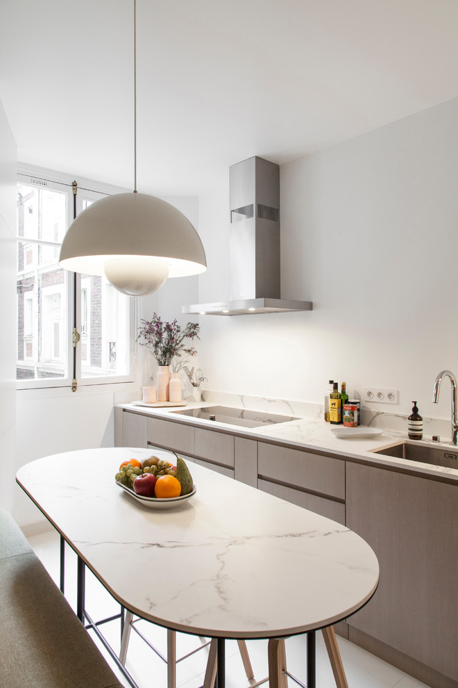 Mid-sized contemporary l-shaped separate kitchen in Paris with a single-bowl sink, quartz benchtops, white splashback, white benchtop, flat-panel cabinets, beige cabinets, marble splashback, panelled appliances, ceramic floors, no island and beige floor.