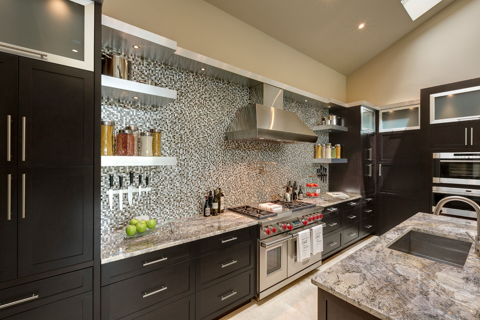 This is an example of a transitional kitchen in Orlando with shaker cabinets, dark wood cabinets, multi-coloured splashback, mosaic tile splashback, stainless steel appliances, with island and an undermount sink.