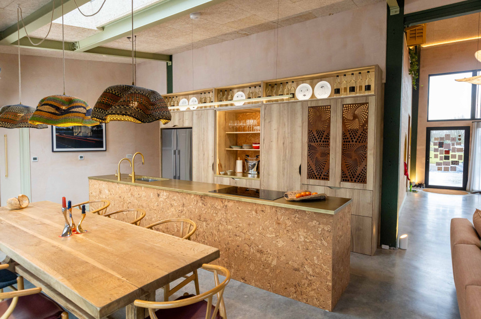 Expansive urban galley kitchen/diner in Kent with concrete flooring, grey floors, a submerged sink, flat-panel cabinets, light wood cabinets, stainless steel appliances, an island and exposed beams.