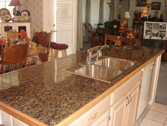 Mid-sized traditional open plan kitchen in Dallas with a double-bowl sink, raised-panel cabinets, white cabinets, granite benchtops, beige splashback, white appliances, linoleum floors and with island.