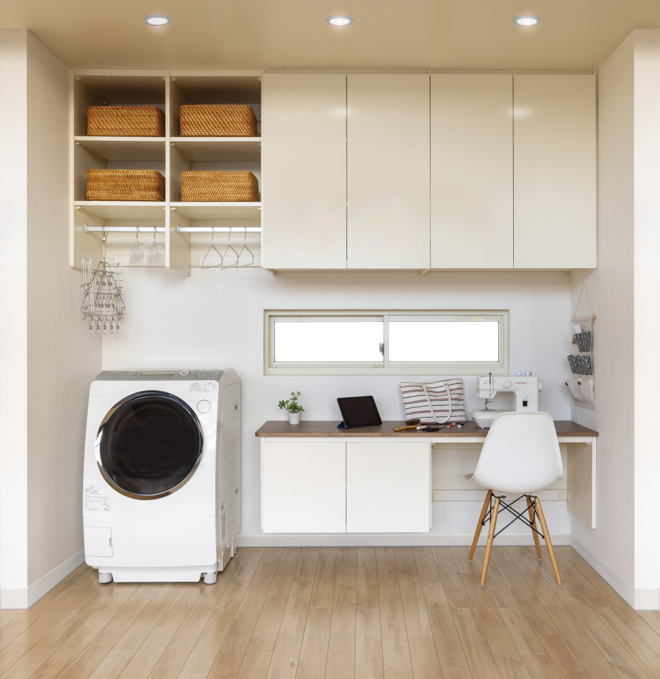 Example of a zen laundry room design in Other
