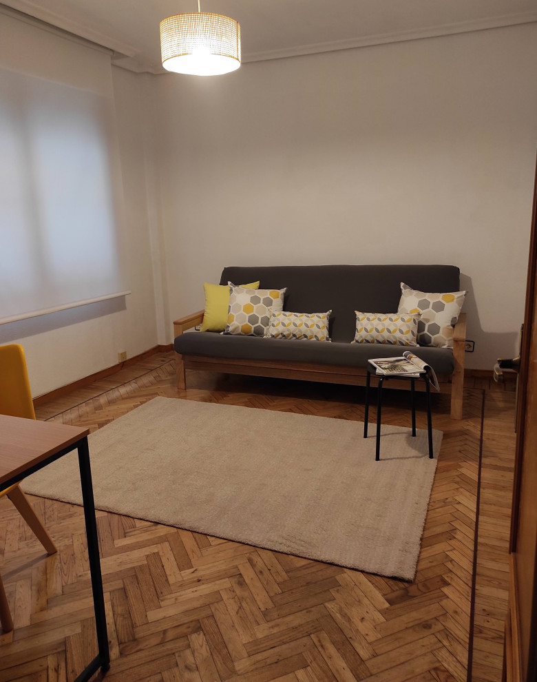 Bedroom - scandinavian guest light wood floor bedroom idea in Other with white walls