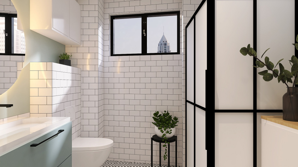 Foto på ett mellanstort industriellt badrum med dusch, med vita skåp, en hörndusch, en vägghängd toalettstol, vit kakel, tunnelbanekakel, gröna väggar, ett väggmonterat handfat, svart golv och dusch med skjutdörr
