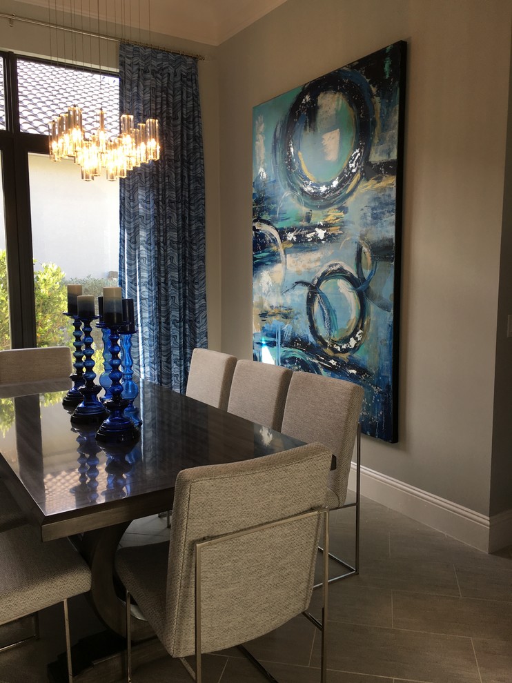 This is an example of a transitional dining room in Miami with grey walls, porcelain floors and no fireplace.