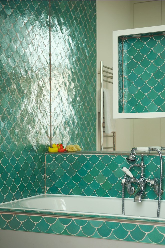 Inspiration for a transitional bathroom in London with green tile.
