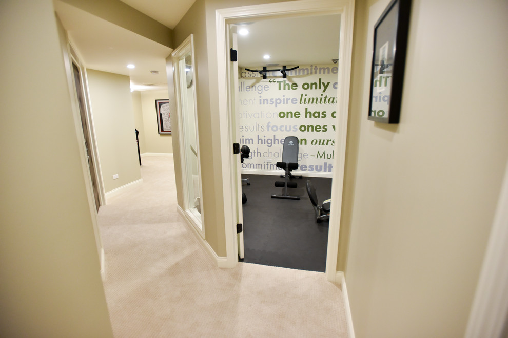 This is an example of a contemporary home weight room in Chicago with beige walls.