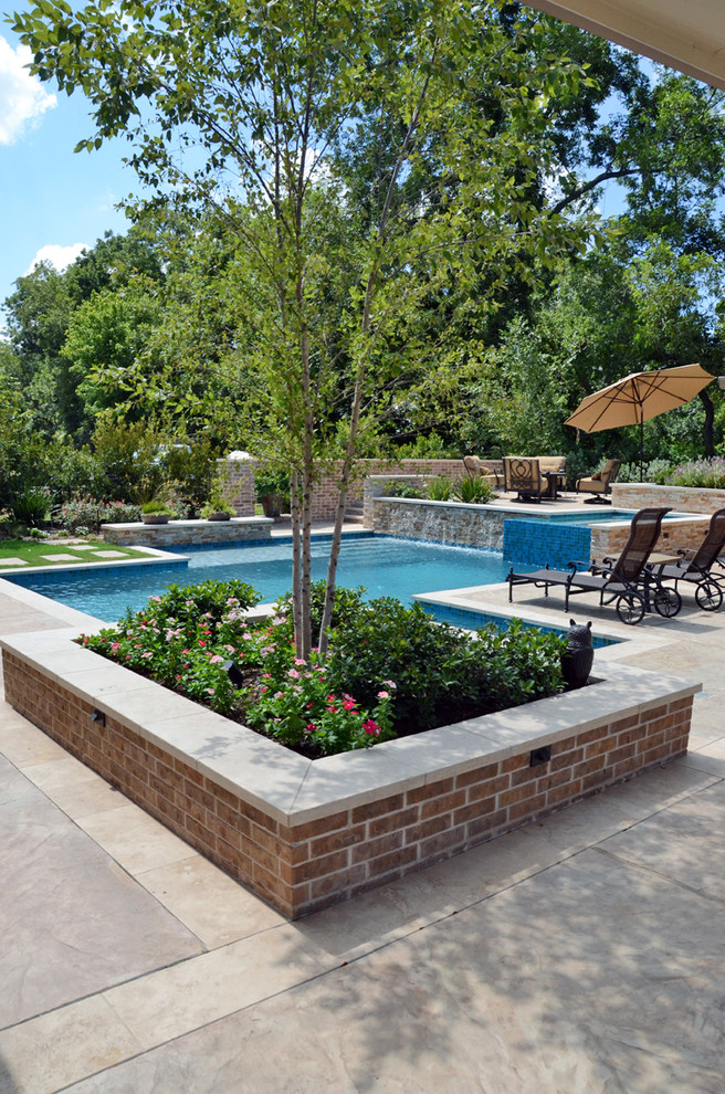 Design ideas for an expansive country backyard custom-shaped natural pool in Houston with a hot tub and tile.