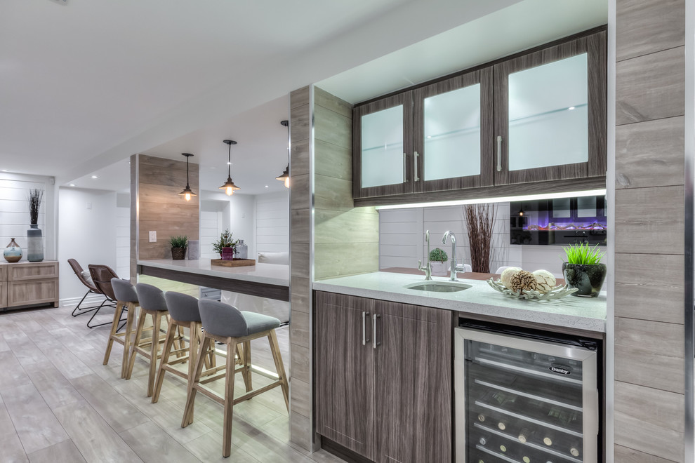 Inspiration for a beach style galley seated home bar in Toronto with an undermount sink, shaker cabinets, dark wood cabinets, quartzite benchtops and laminate floors.