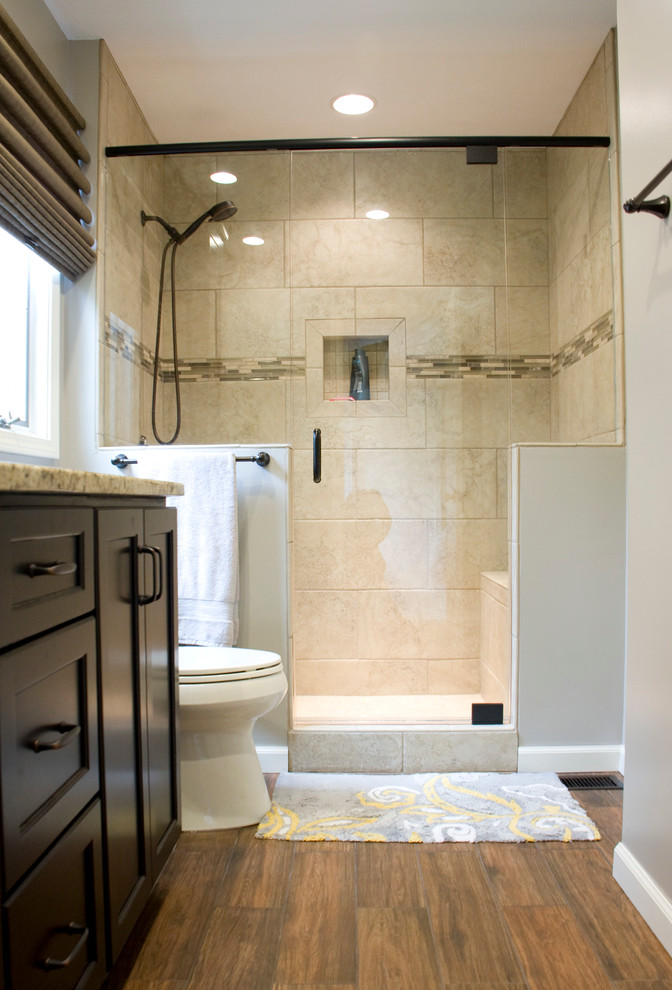 Example of a small master brown tile and ceramic tile ceramic tile alcove shower design with an undermount sink, shaker cabinets, dark wood cabinets, granite countertops, a two-piece toilet and gray walls
