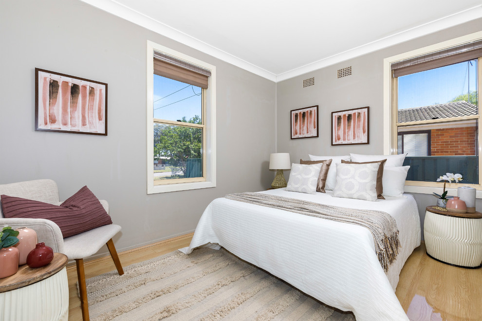 Inspiration for a transitional bedroom in Sydney with grey walls, light hardwood floors and beige floor.